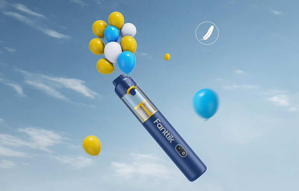 The Fanttik cordless car vacuum cleaner floats among colorful balloons against a backdrop of a blue sky.
