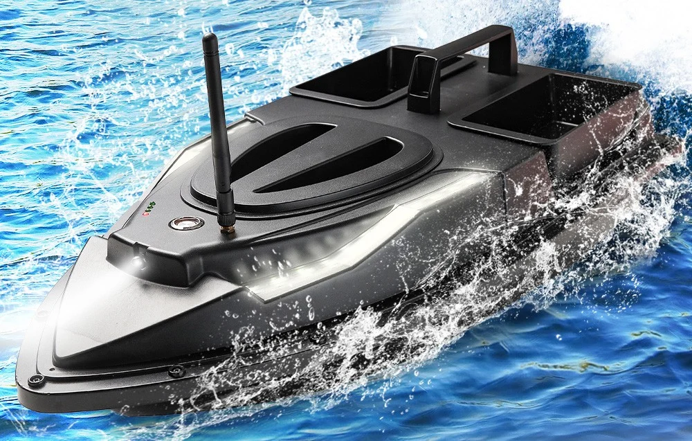 Black RC bait boat at full speed with a water fountain and two empty bait containers