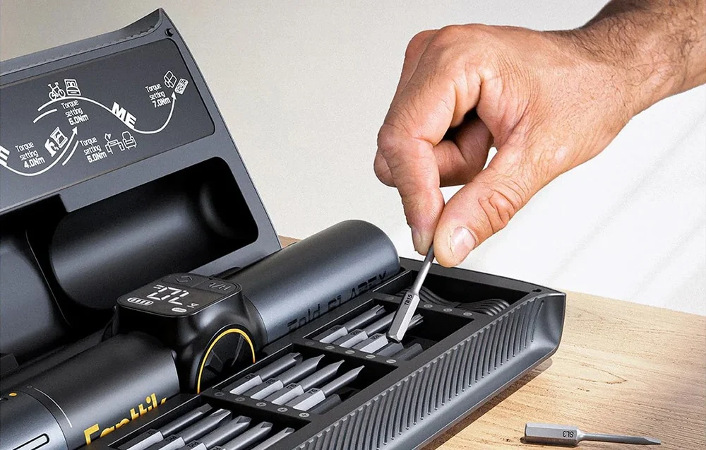 A man removes a bit from a dedicated case.