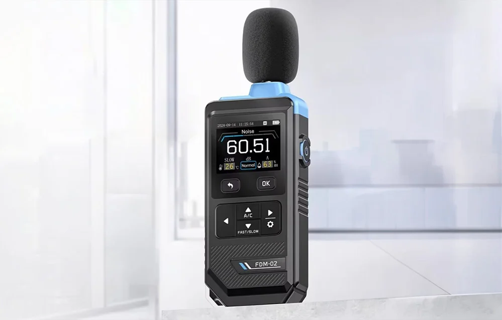 Sound level meter with a built-in screen on a bright, blurred interior background