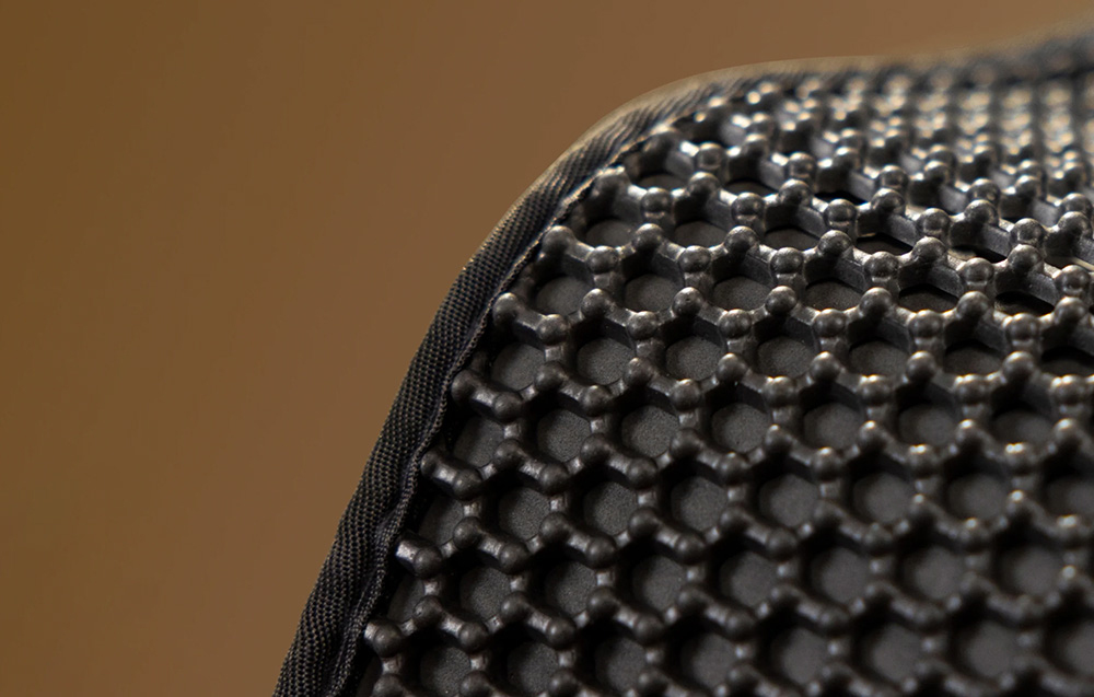 Close-up of a corner of the black mat with a raised, hexagonal pattern