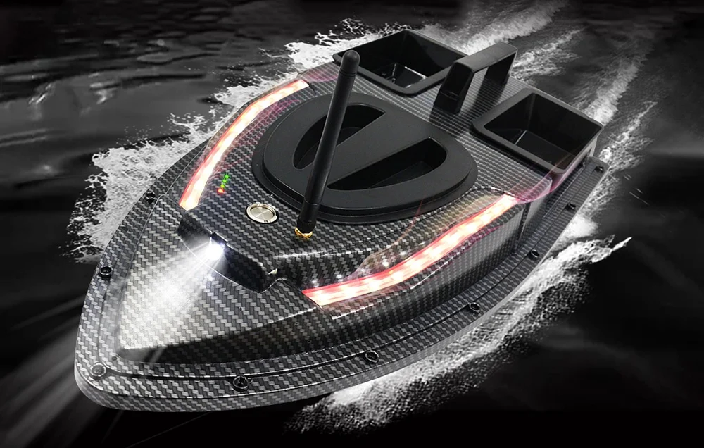Carbon fiber bait boat with red and white LED stripe in motion, white light in front, water ripples all around