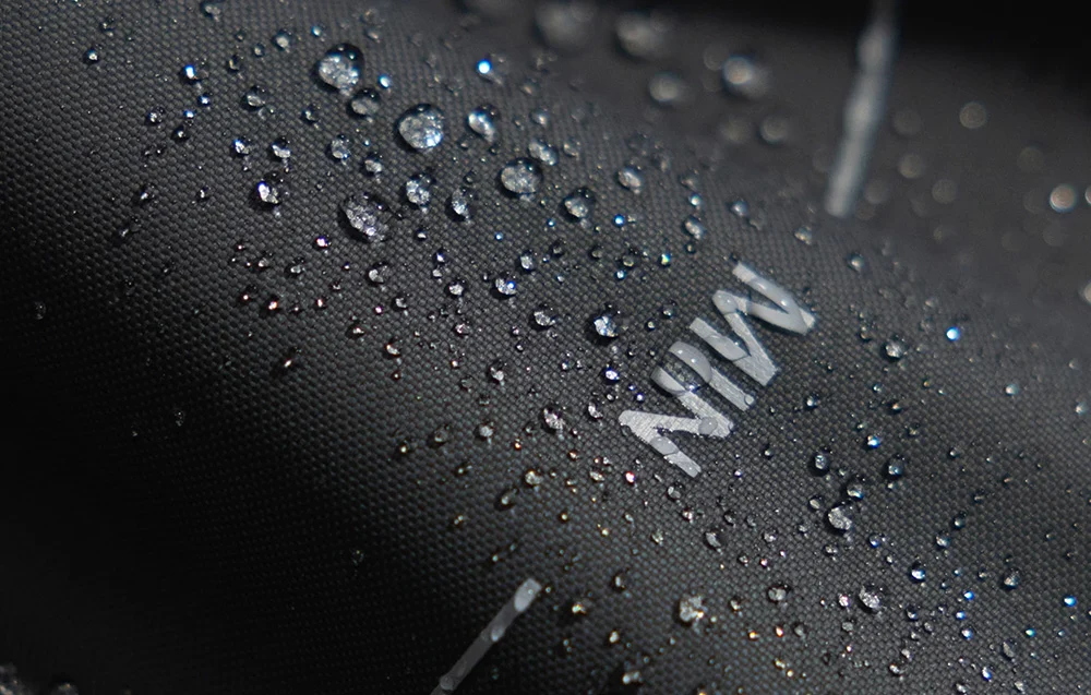 Water droplets on the black, waterproof surface of the bag