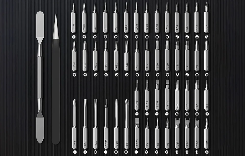 A set of bits, tweezers and a jack tool on a black background.