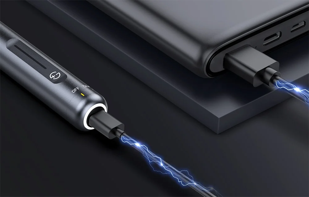 Grinder connected to a powerbank using a USB cable.
