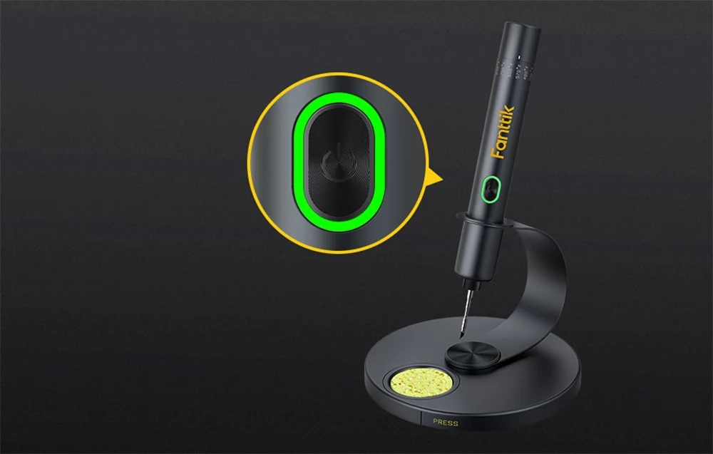 Black Fanttik soldering iron standing on stand with marked button with green backlight.