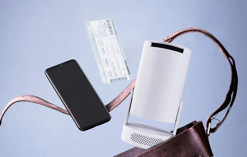 A white projector, a smartphone, and an airline ticket float above an open, brown leather bag on a light background