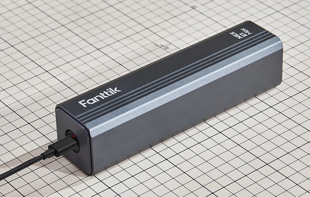 Electric screwdriver in Fanttik case connected to USB cable.