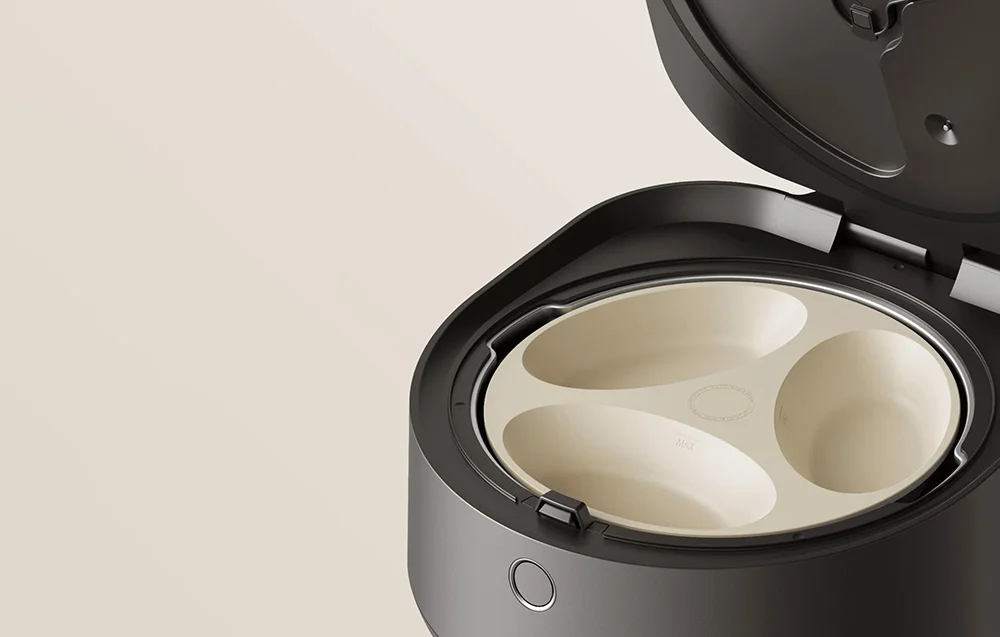 An open automatic cat feeder with a removable, three-compartment insert in a light color