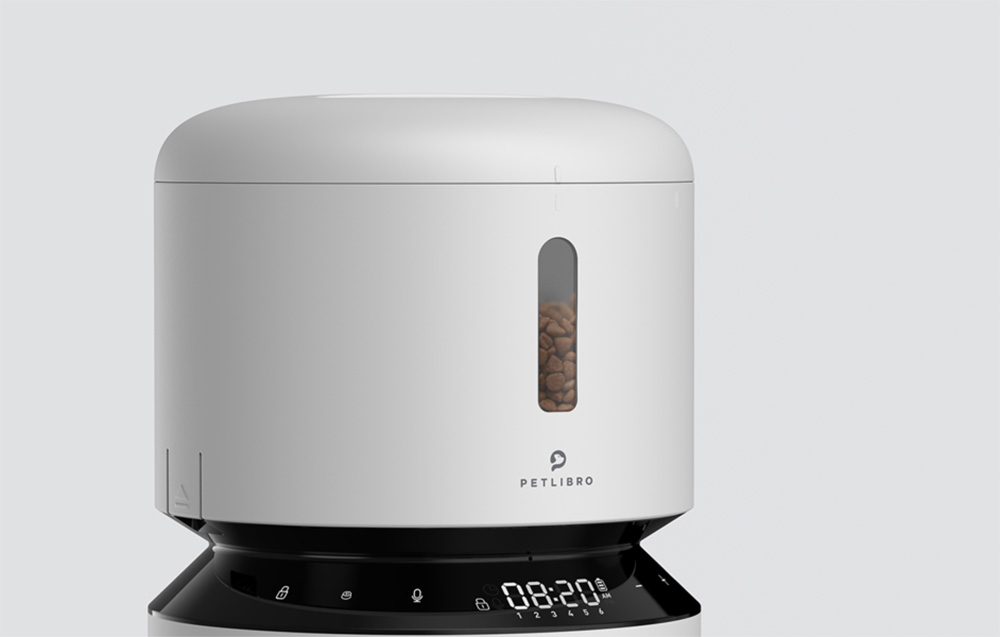 White automatic cat feeder with a transparent food window and a control panel with a display at the base