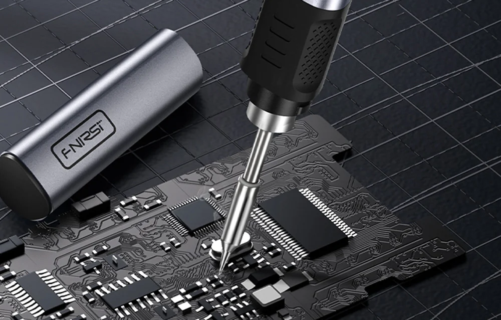 FNIRSI soldering iron during precision soldering on a printed circuit board.