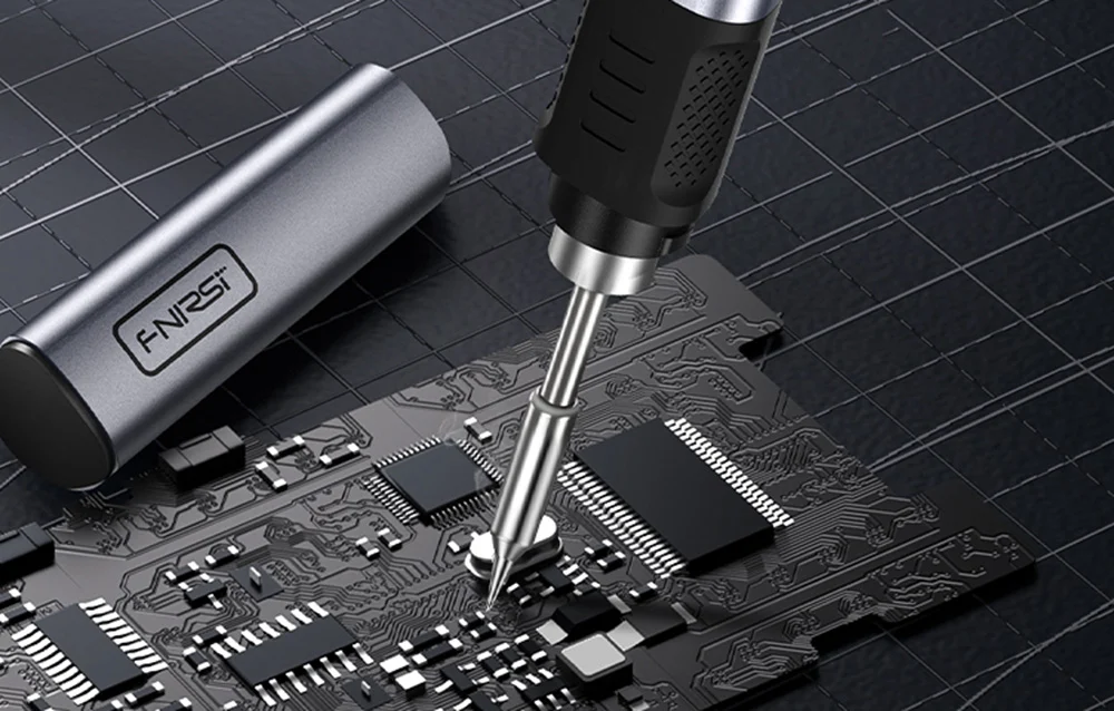 FNIRSI soldering iron during precision soldering on a printed circuit board.